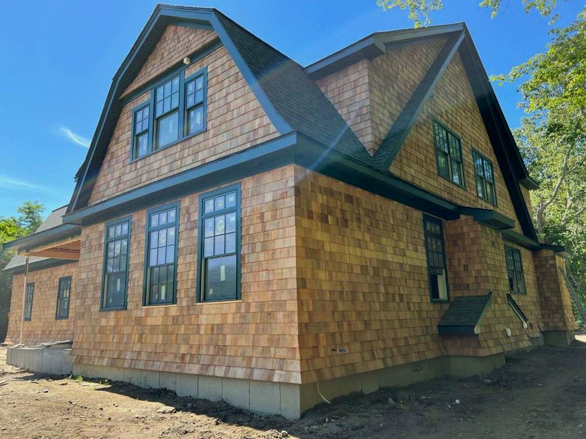 New custom home with cedar shingle siding and gambrel roof