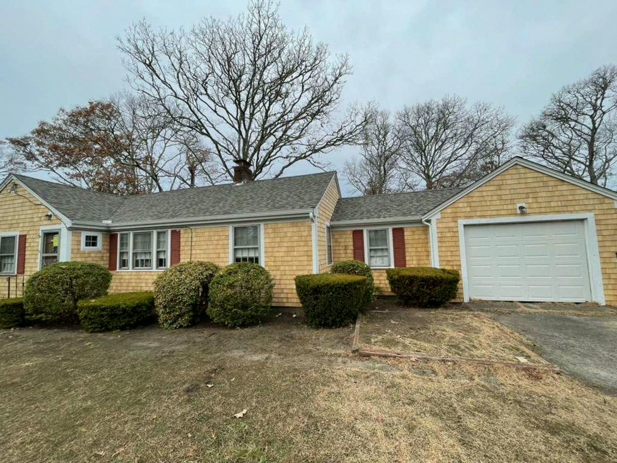 Ranch house fully re-shingled in cedar, garage wing beyond